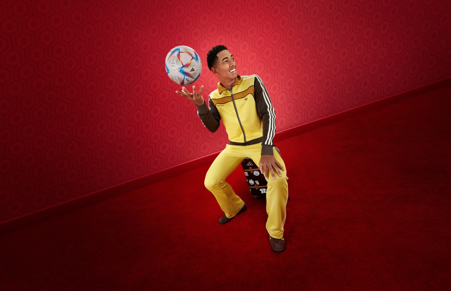 Jude Bellingham holding FIFA World Cup adidas ball wearing adidas