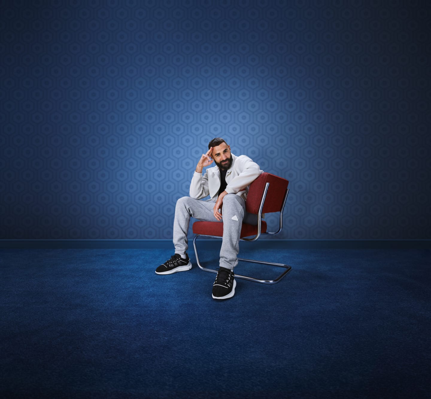 Karim Benzema sitting in chair wearing adidas