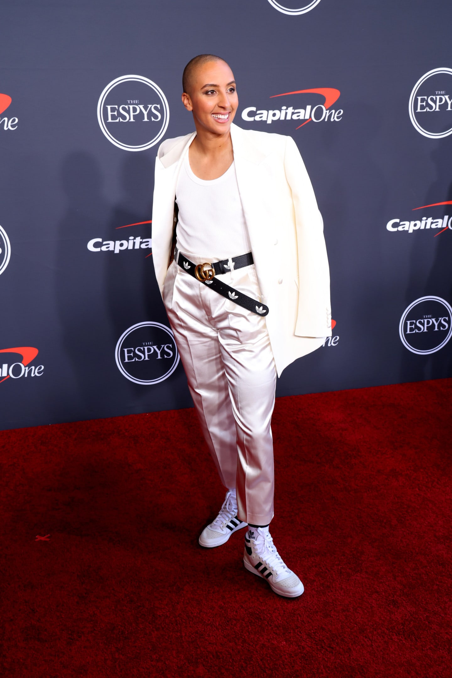 Person wearing white clothing with adidas belt and adidas shoes