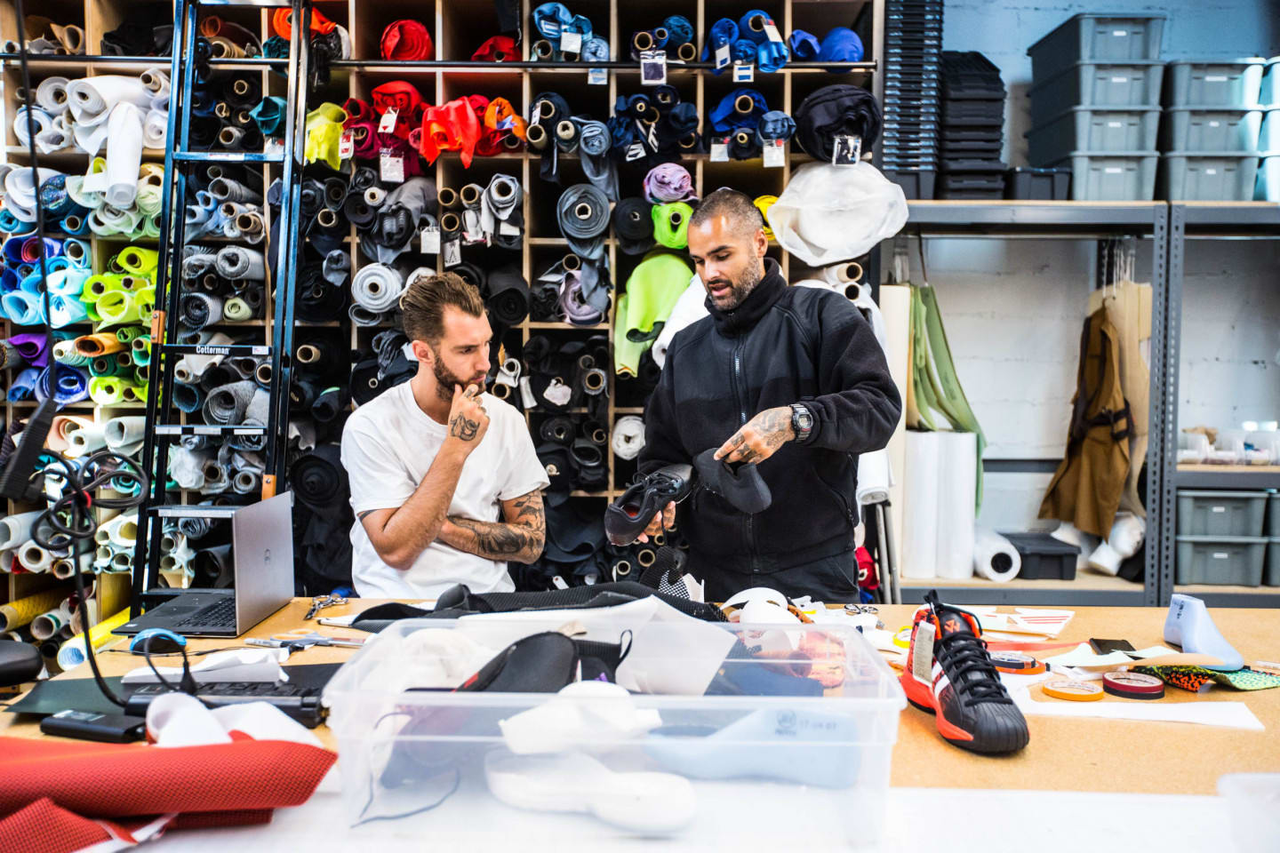 Two men work collaboratively in a design studio.