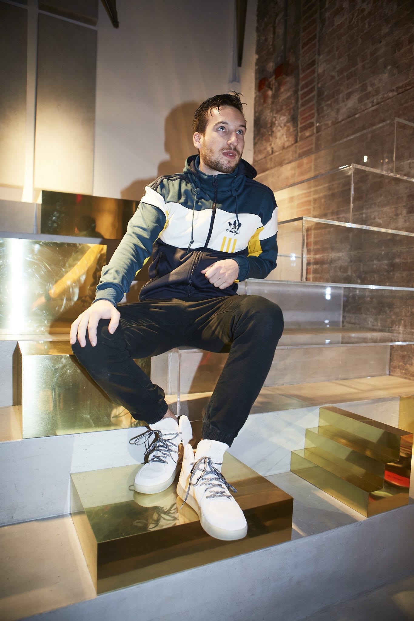 Man sitting on glass stairs creators in NYC