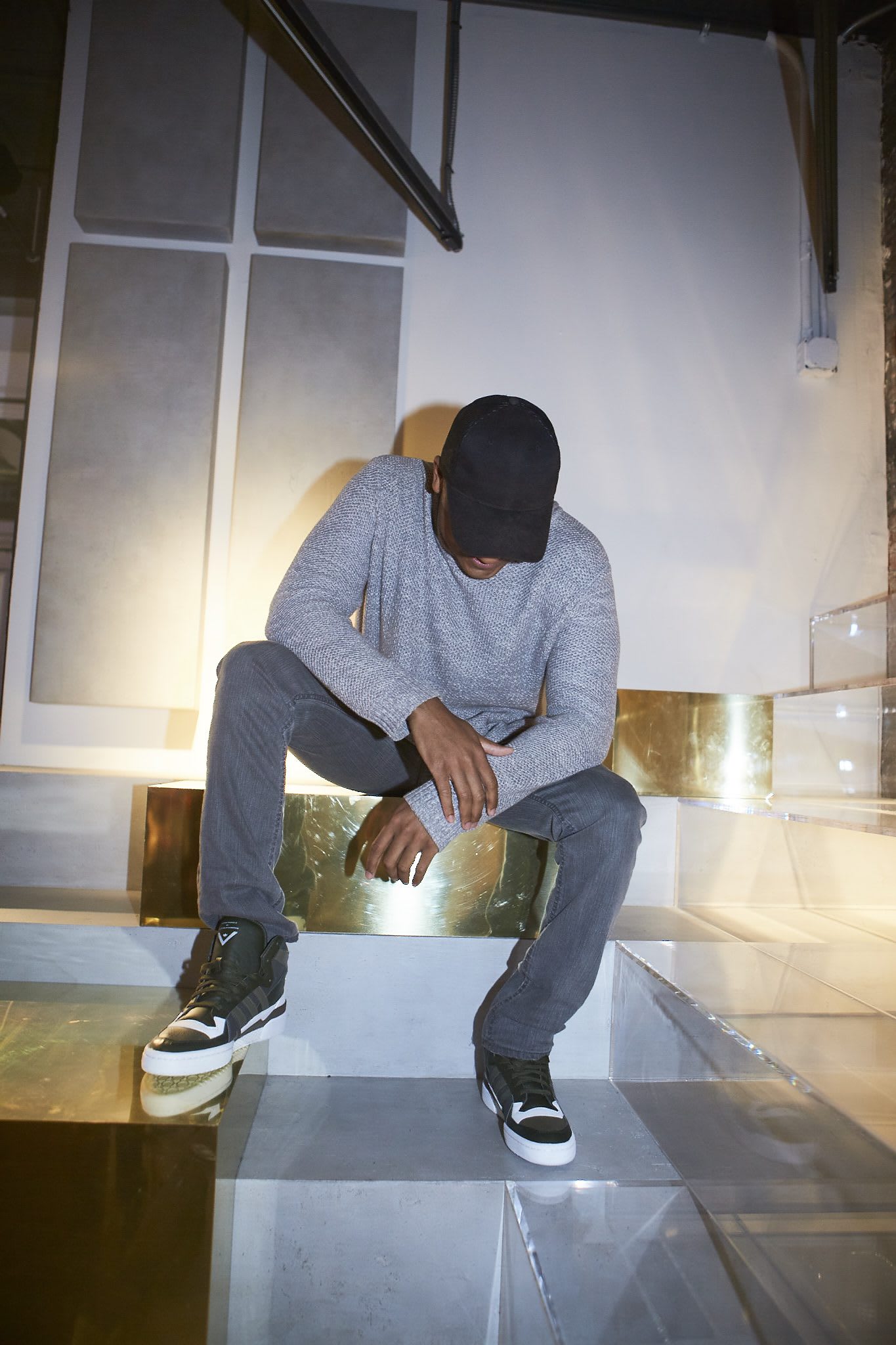 man looking down sitting on stairs creators in NYC