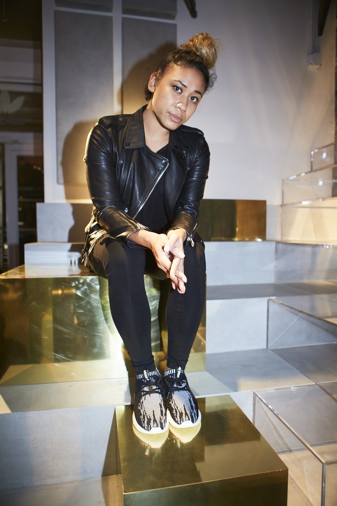 girl with leather jacket sitting on stairs creators in NYC