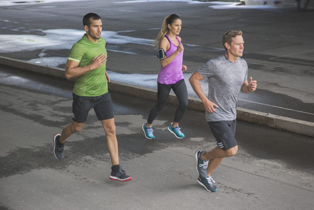 three runners on the street setting goals exercise with like-minded people