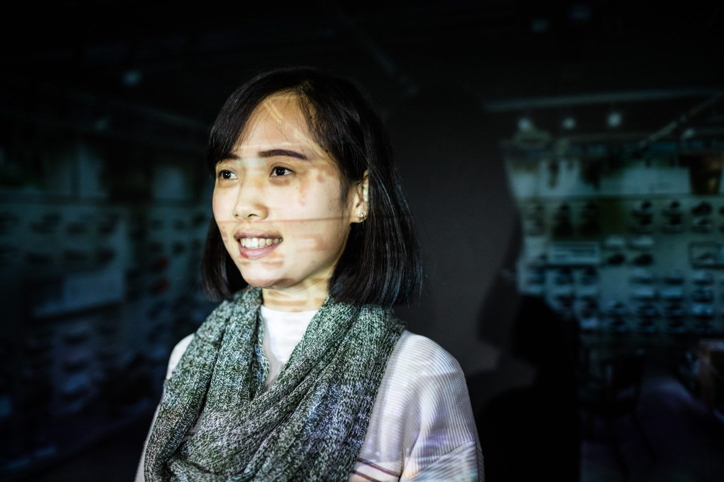 Woman smiling with a proection behind her