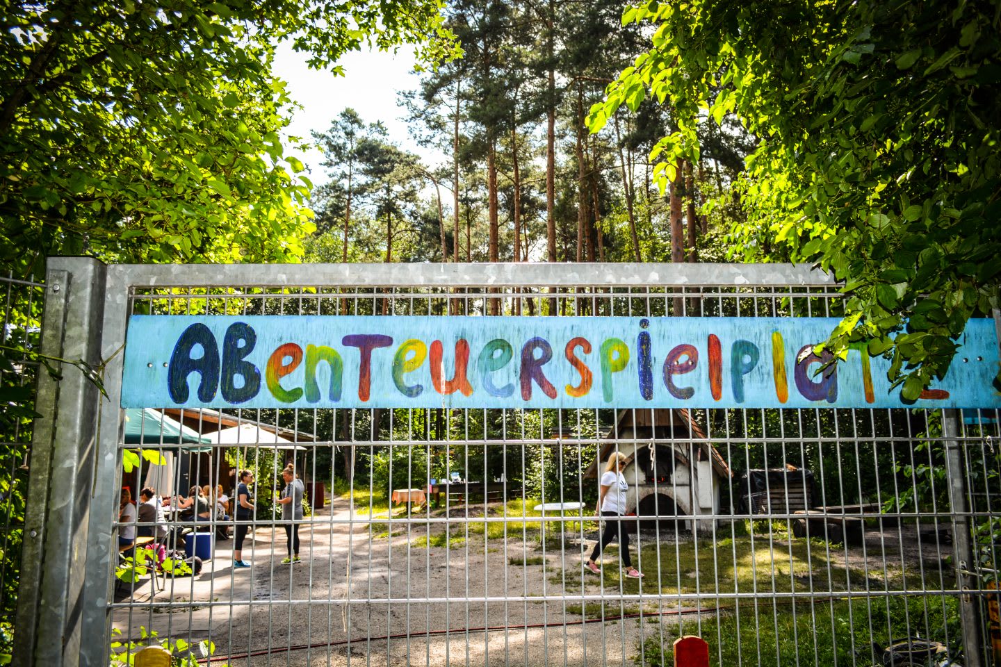 abenteuerspielplatz sign at a metal fence