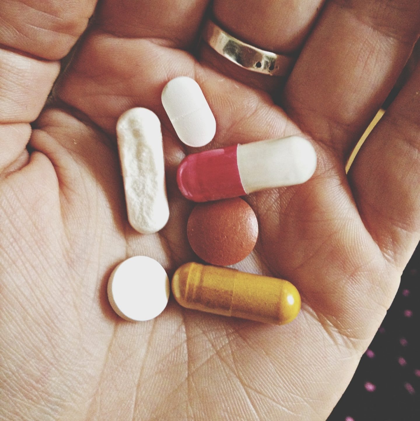 Cropped Hand Holding Various Pills And Capsules