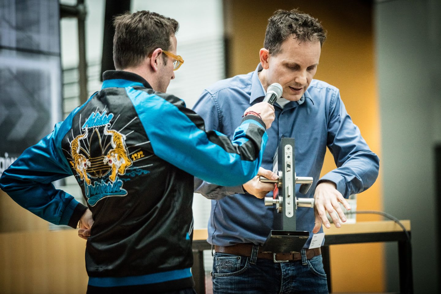 One guy is interviewing another guy with a microphone about Biohacking Implants