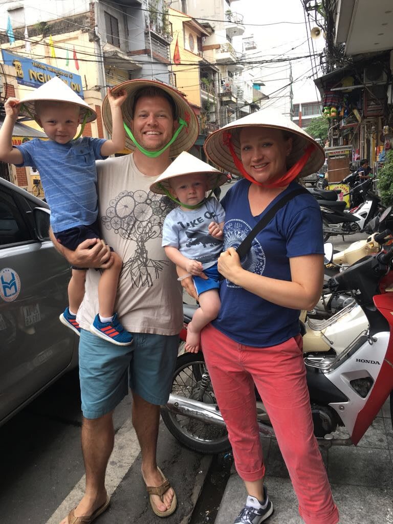 Family in Asia two boys hats smiling