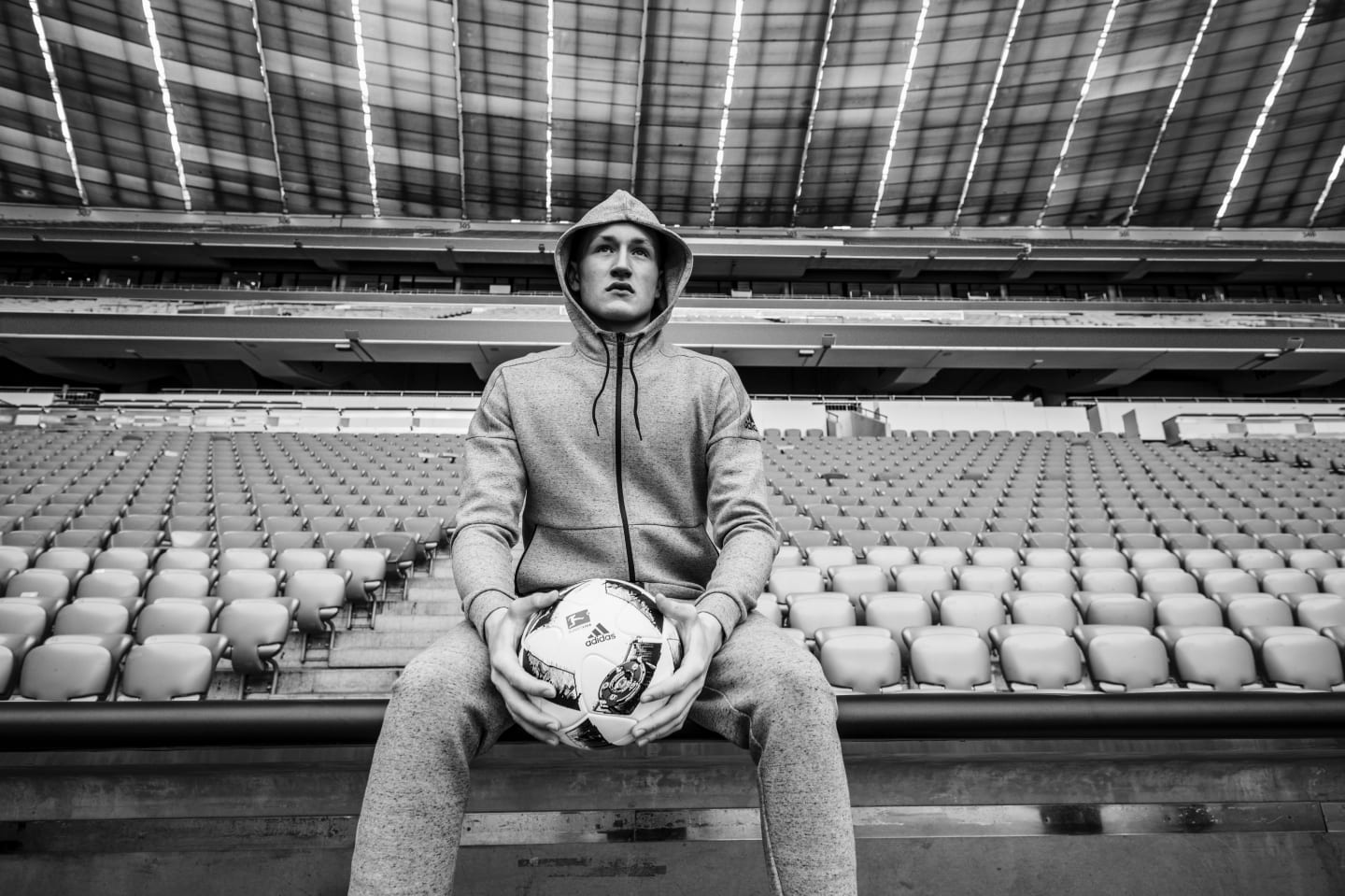 athlete-in-empty-arena-holding-ball-focusing-the-how-of-mental-strength