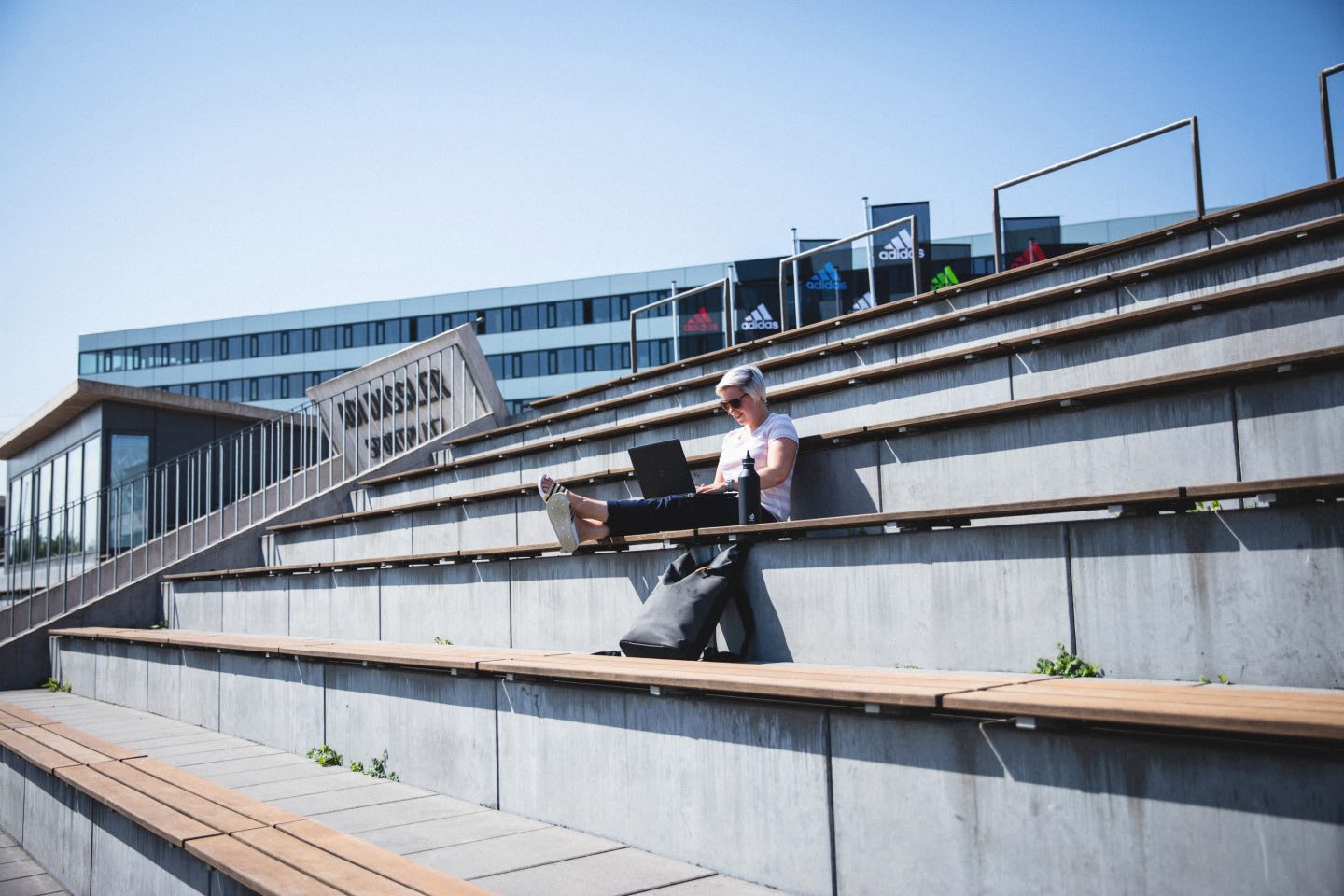 Girl working in the stadium stands with laptop, Work,Outside,Stadium, Stands, adidas, GamePlanA