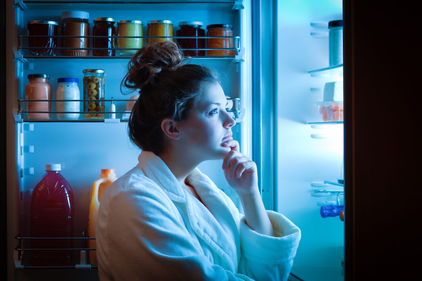 A young dieting woman standing in front of the refrigerator, contemplating and thinking about what to eat for hunger. Making choices and decision for healthy lifestyle, adidas, GamePlan A, nutrition, health