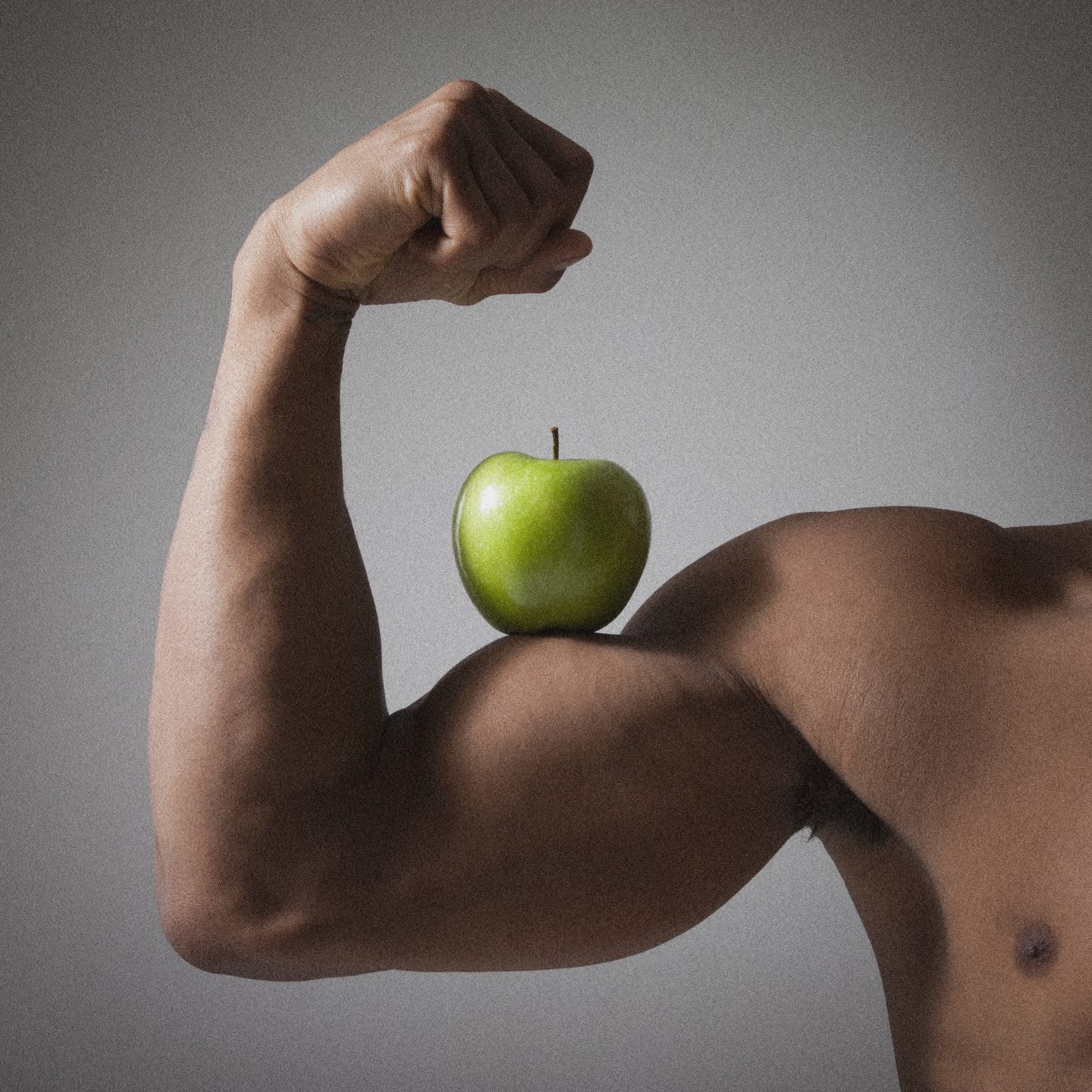 Muscle arm balances a green apple, nutrition, fitness, health, clean eating, GamePlan A, adidas, business