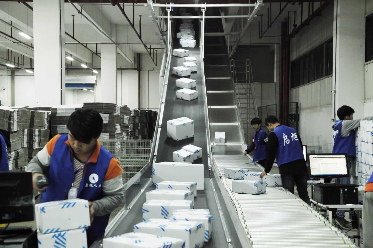 Working in Chinese Factory on a belt where packages are ready for distribution