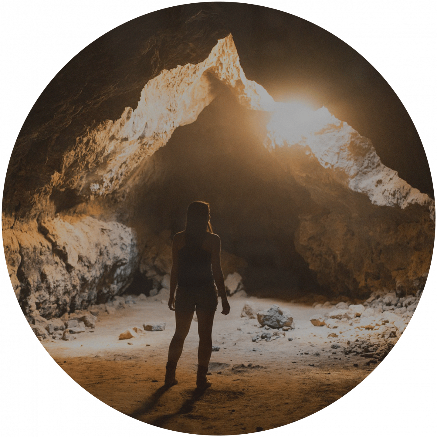 A woman is standing in front of a cave entrance. team building, cave, explorer, exploration, team event, outdoor, adventure, adidas, GamePlan A, team bonding
