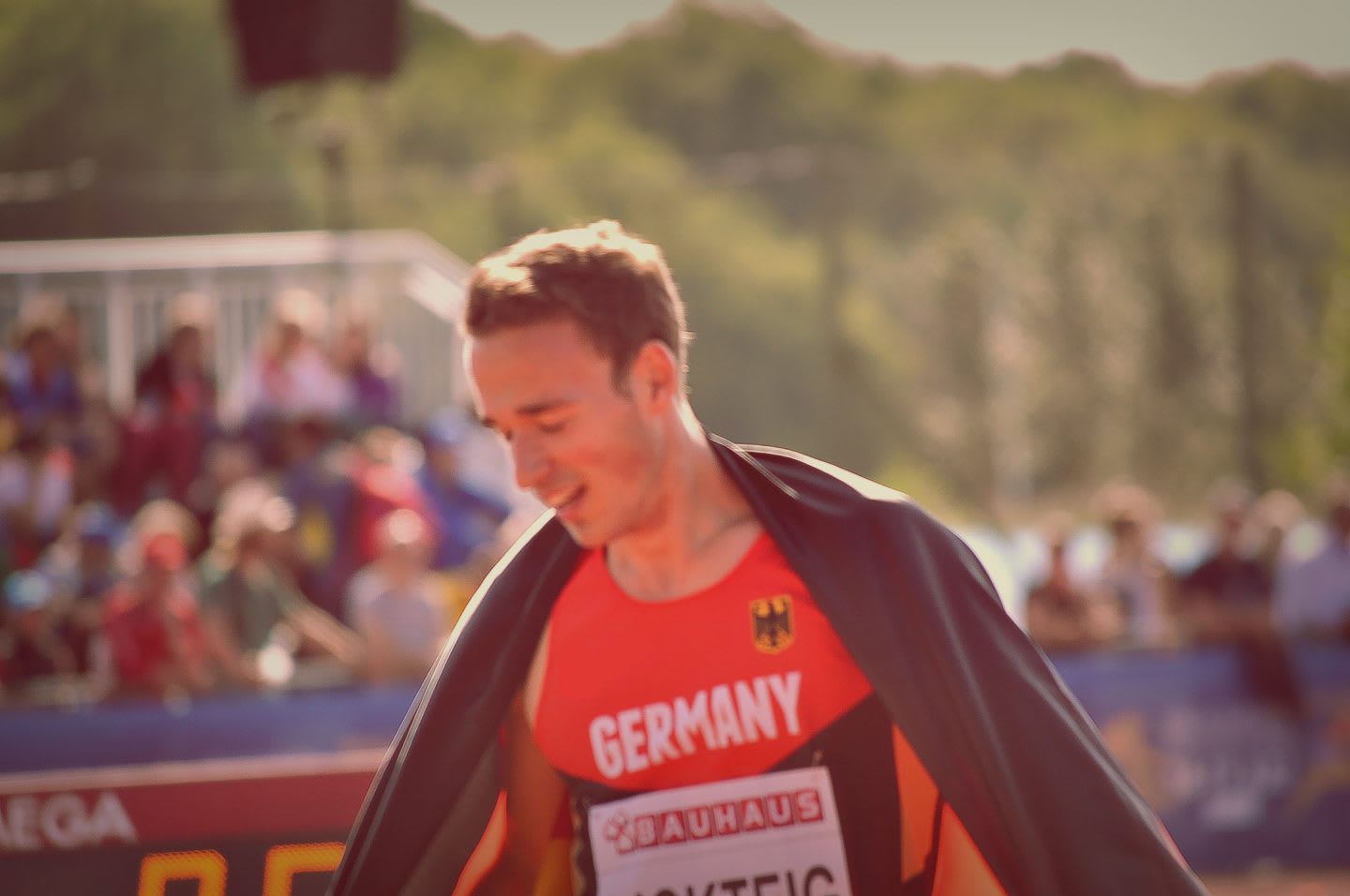 An athlete after a hurdling race walking the tracks