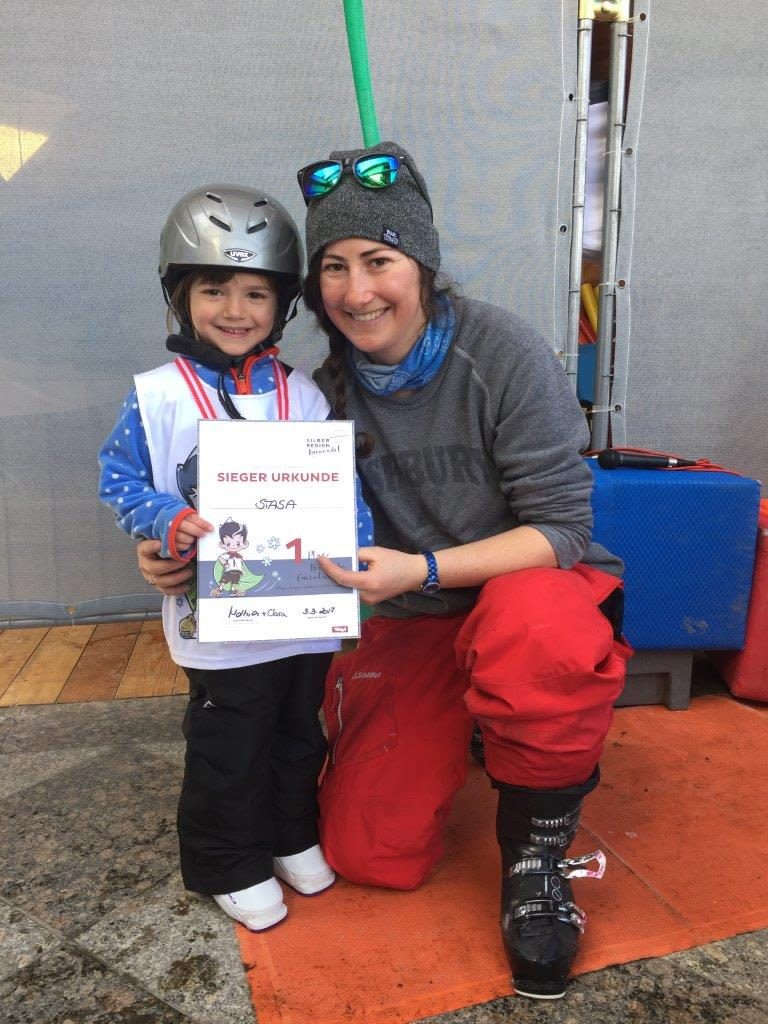 Girl gets her record from her skiing instructor and is smiling