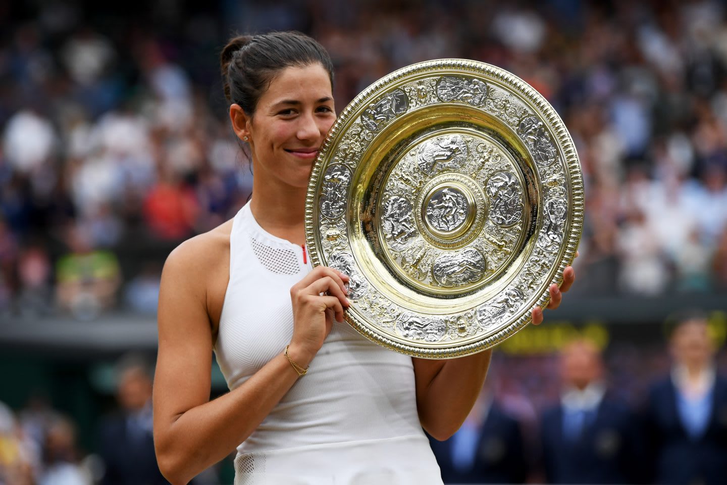 Garbine Muguruza is standing on the tennis court, holding a trophy. Athlete; Tennis; Champion; Wimbledon; adidas; GamePlan A; Motivation; Win; Dedication; Inspiration