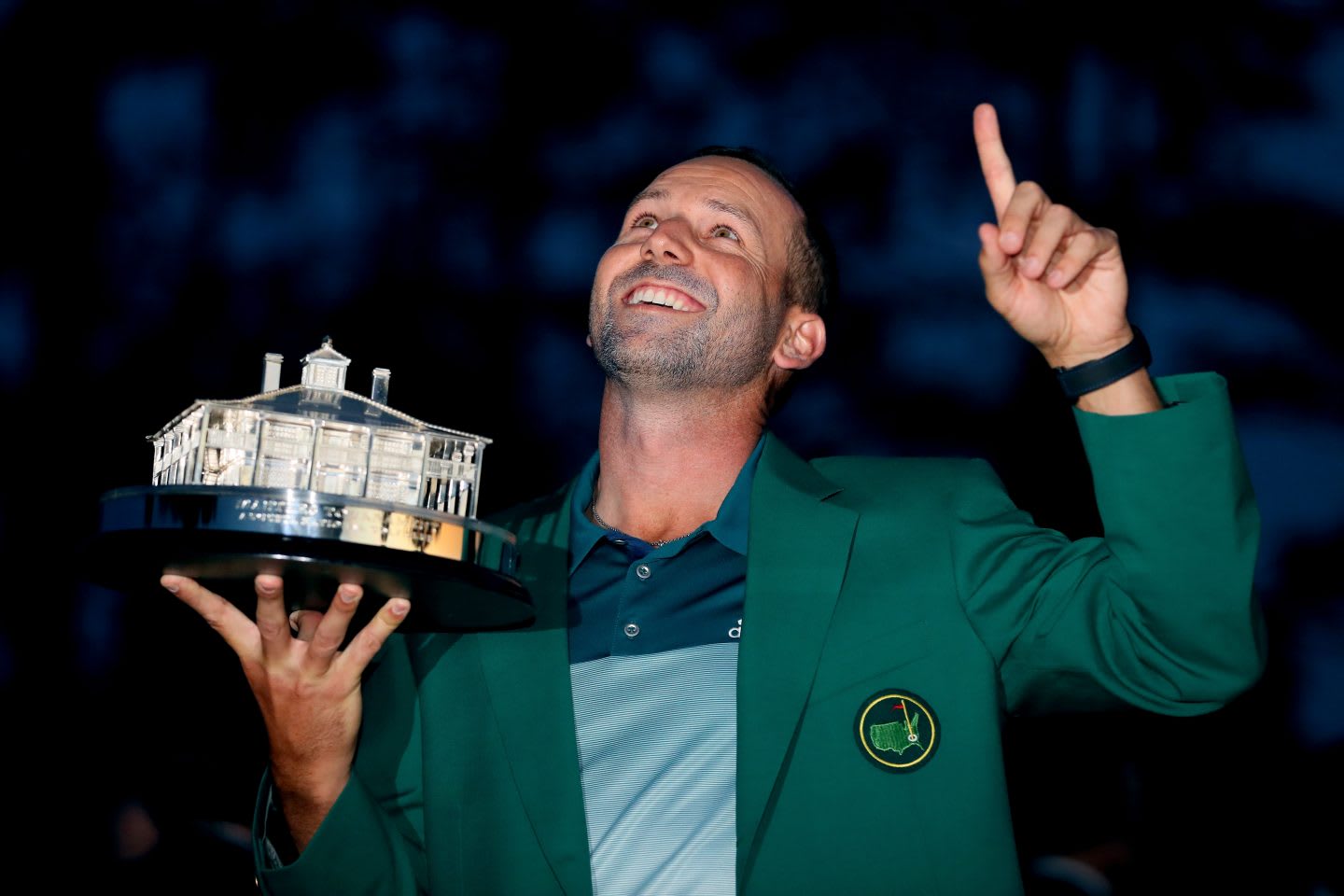 Golfer Sergio Garcia is holding a trophy and pointing one finger to the sky. Gold; Champion; Tournament; Golfer; Athlete; Adidas; Champion; Win; Motivation; Inspiration; Masters