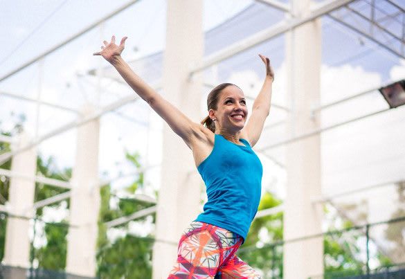 Magdalena Schauenberger is working out, smiling and raising her hands over her head. Workout; Fun; Fitness; Success; Motivation; Mindset; adidas; GamePlan A; Performance