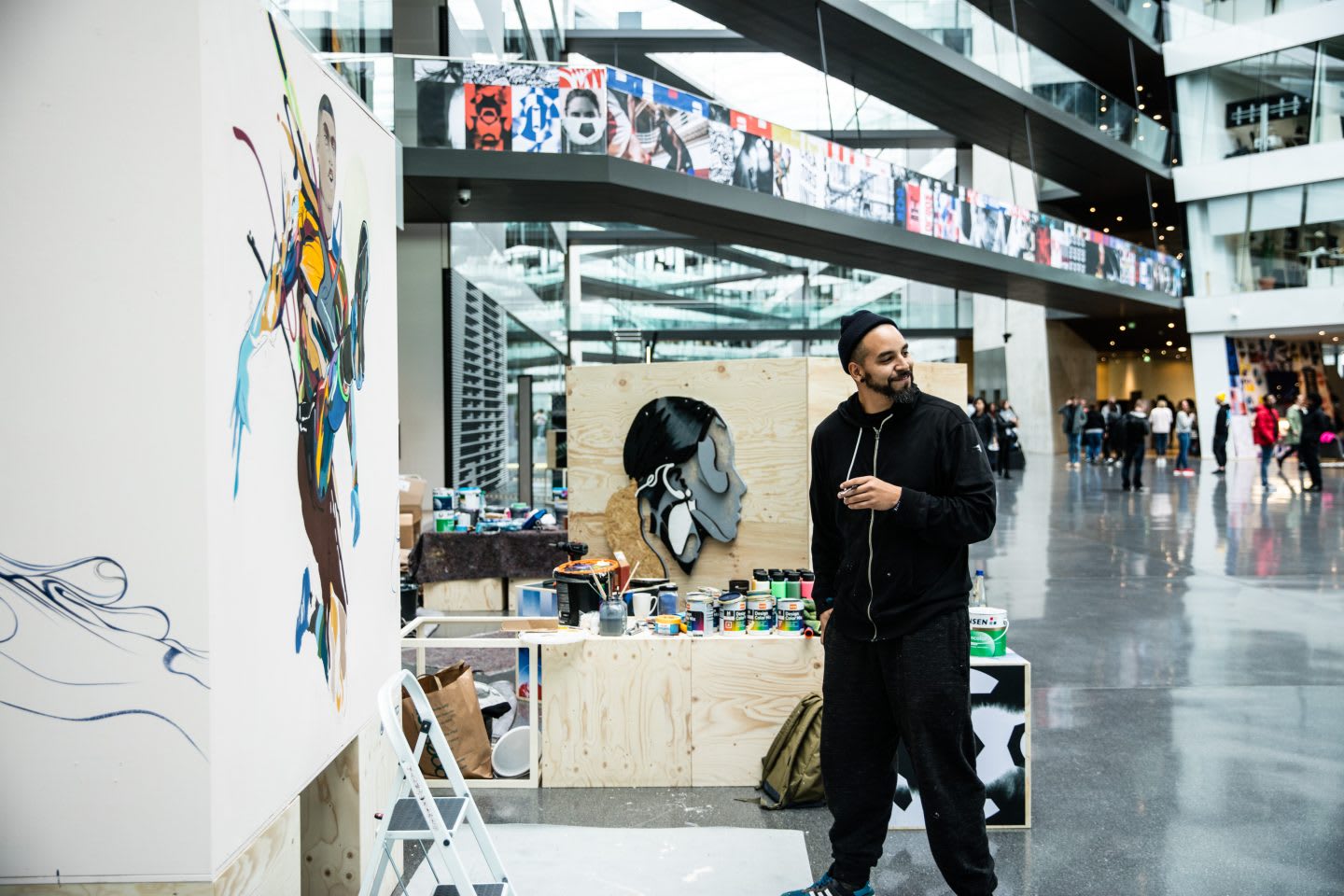 An artist takes a step back and is proud of his work. artist, paint, painting, creativity, confidence