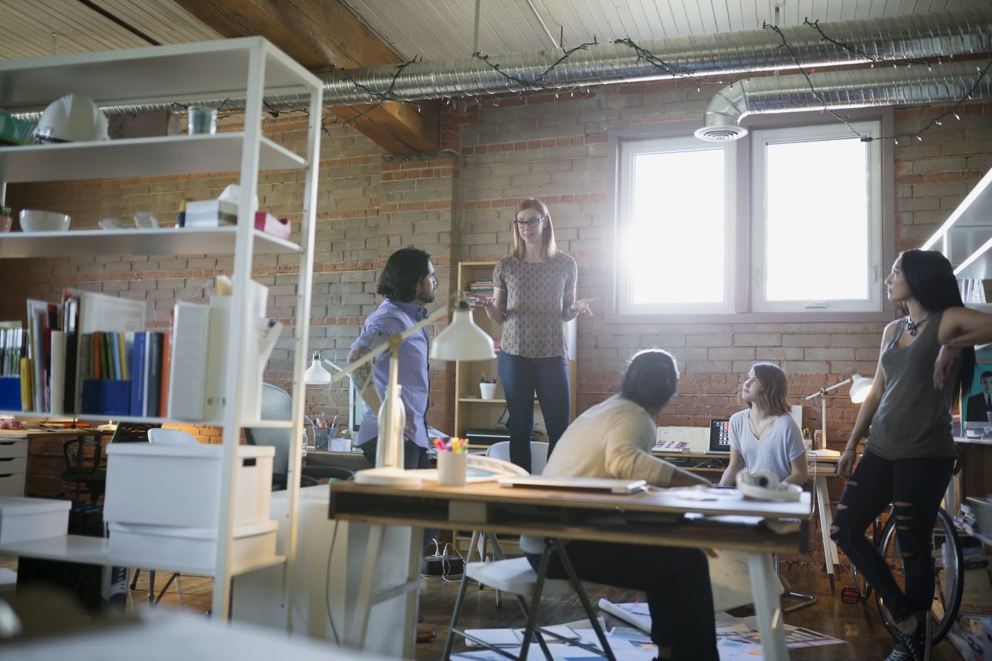 Designer standing on chair leading meeting in office. self-reflection, conference, coaching, self-improvement, impact, perception, introvert, extrovert, adidas, GamePlan A