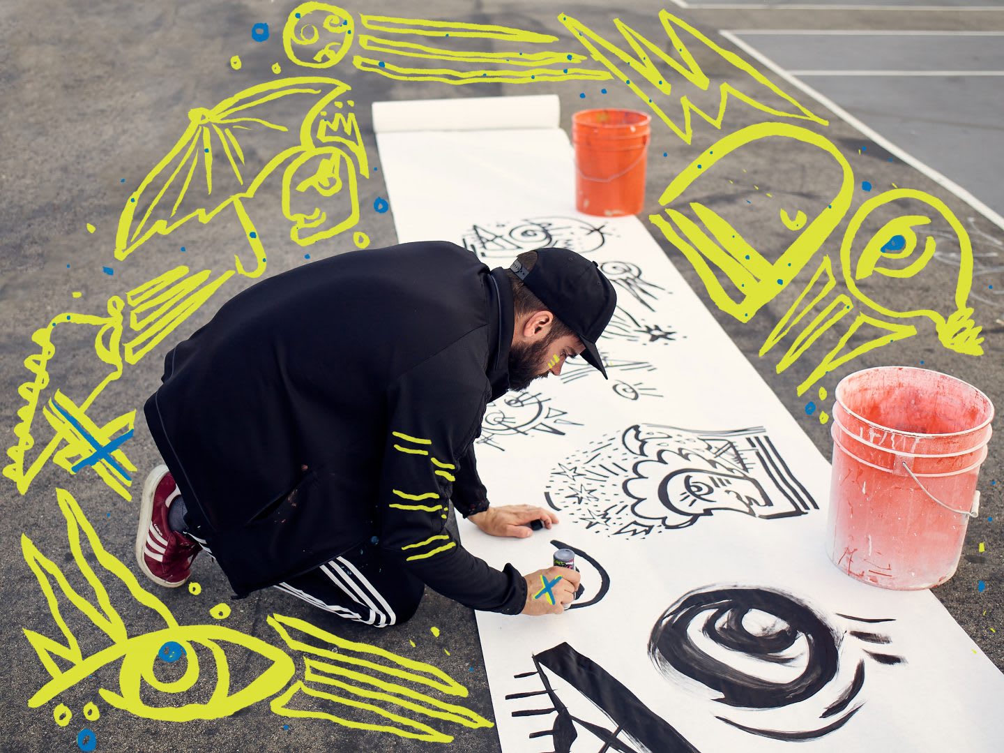 An artist begins his drawings on a large piece of white paper rolled across the street. art, artist, creator, creativity, drawing, doodle