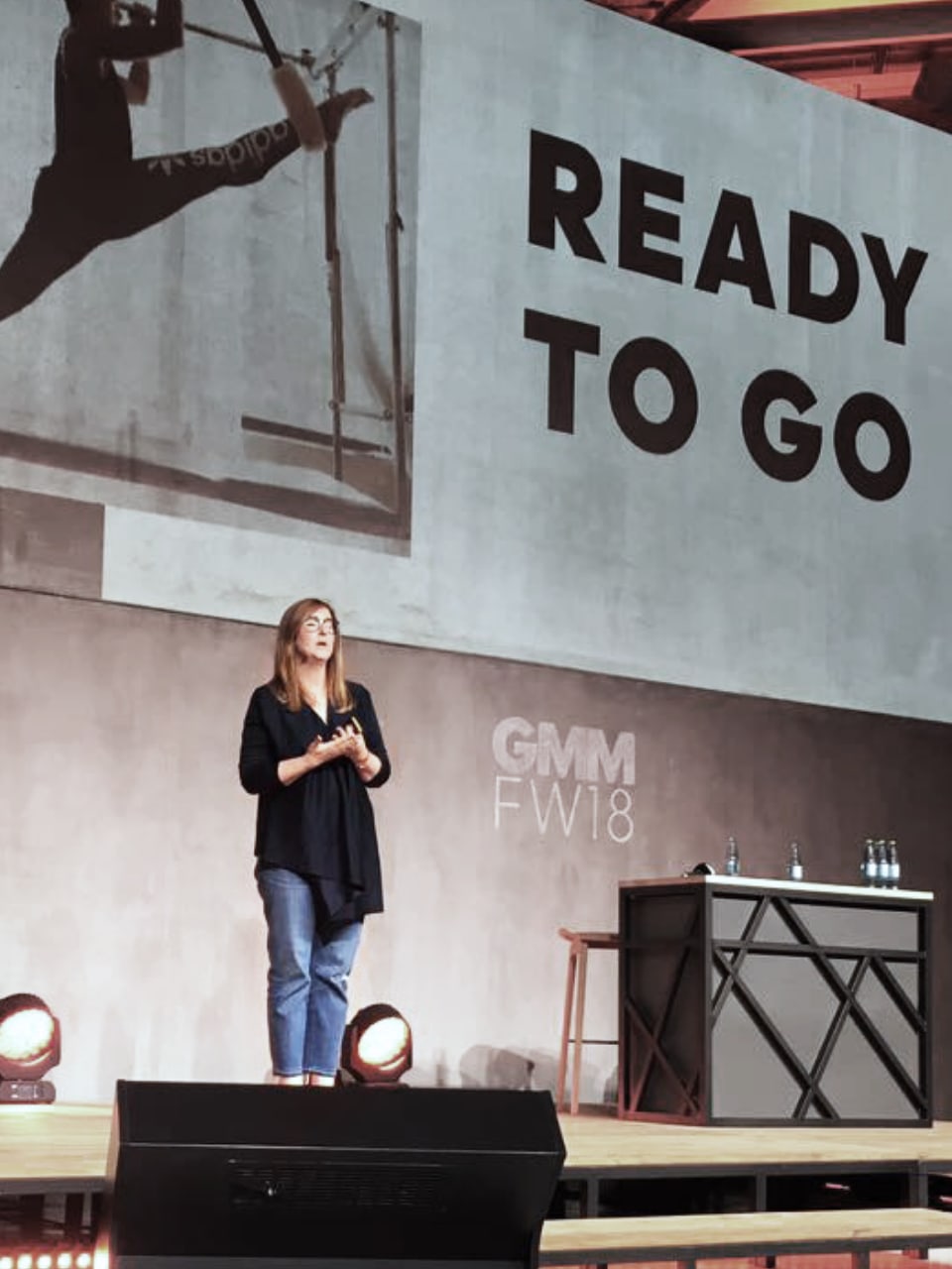 Lisann Costello is presenting on stage during an adidas meeting.