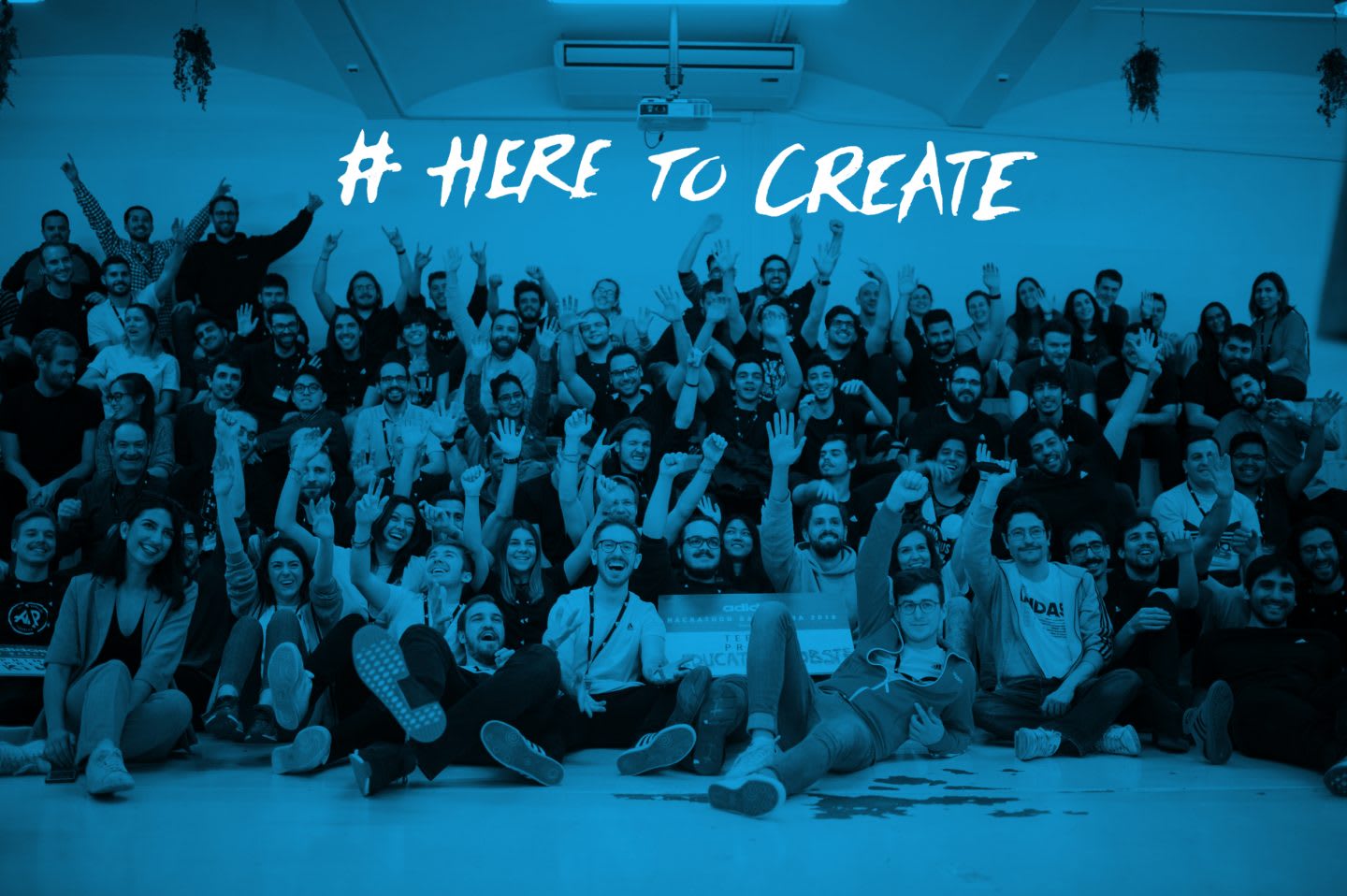 Participants of a Hackathon stand together for group picture cheering in´the camera, digital, ideas, innovation, technology, hackathon, coding, group, team work, project, adidas, GamePlan A