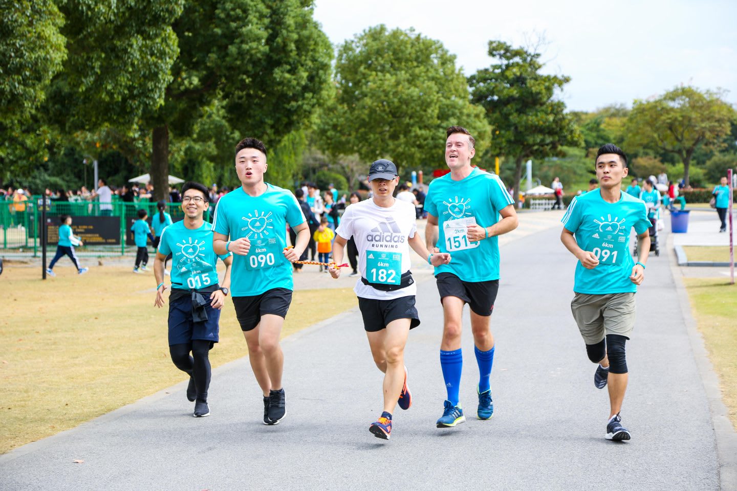 A blind runner and his guide at the Run for Love event surrounded by other volunteers. Running, blind runner, guiding, race, empathy, GamePlan A