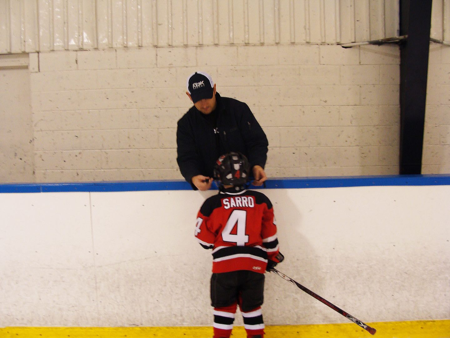 Icehockey coach Dan Sarro coaching his so on the icehockey field