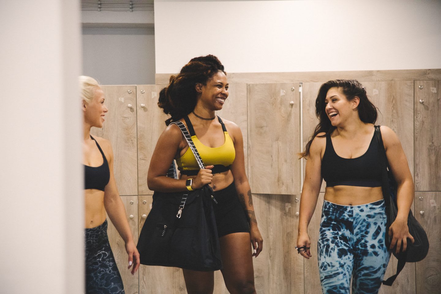 Women at locker room getting ready for training not saying sorry for standing in the way