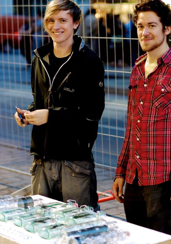 Co-founders of soulbottle Georg Tarne and Paul Kupfer with a table of soulbottles.