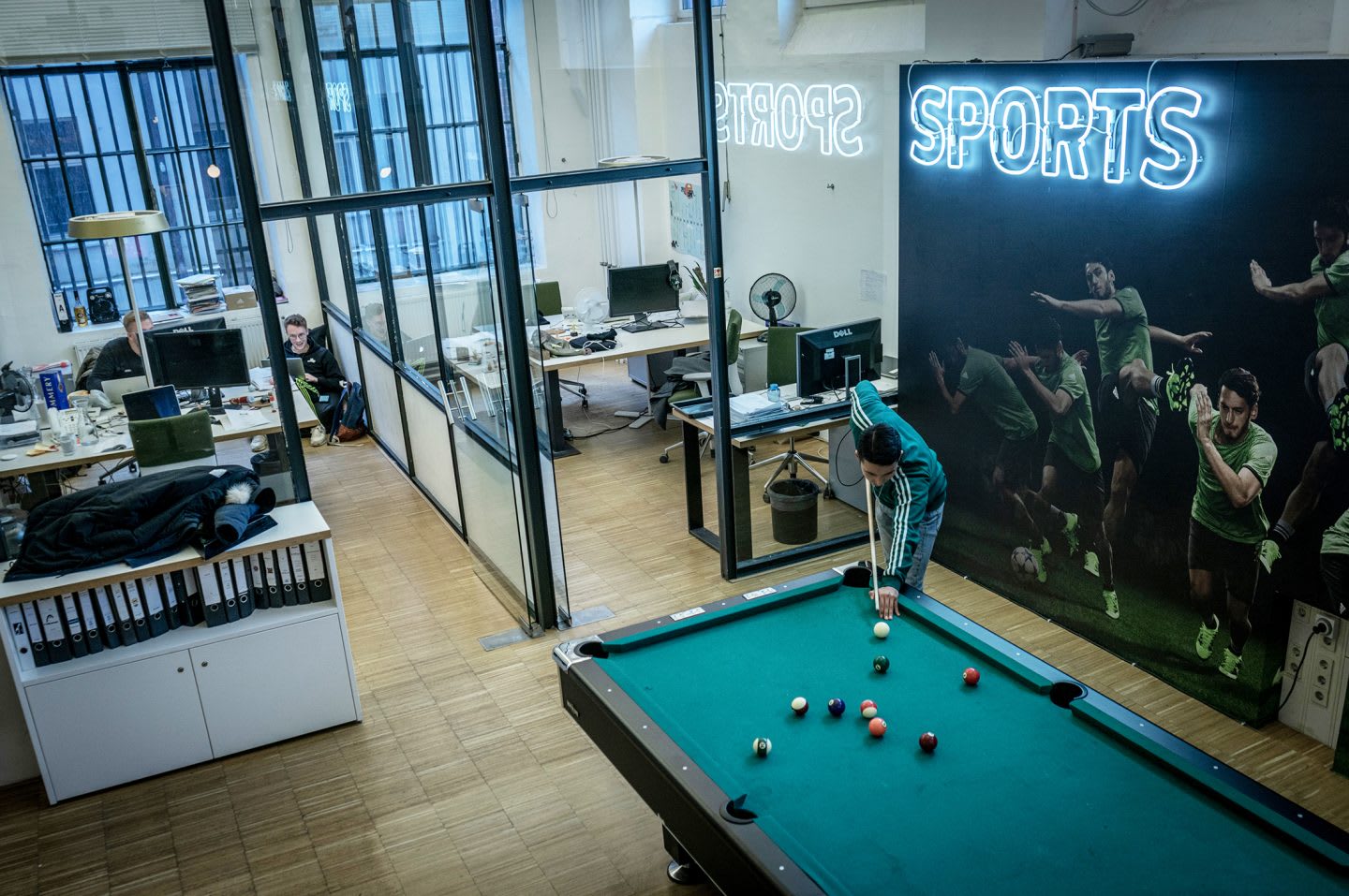 JvM office with a man playing billard. How to build a creative workplace culture, JvM, workplace, collaboration, creativity, team-building, GamePlan A
