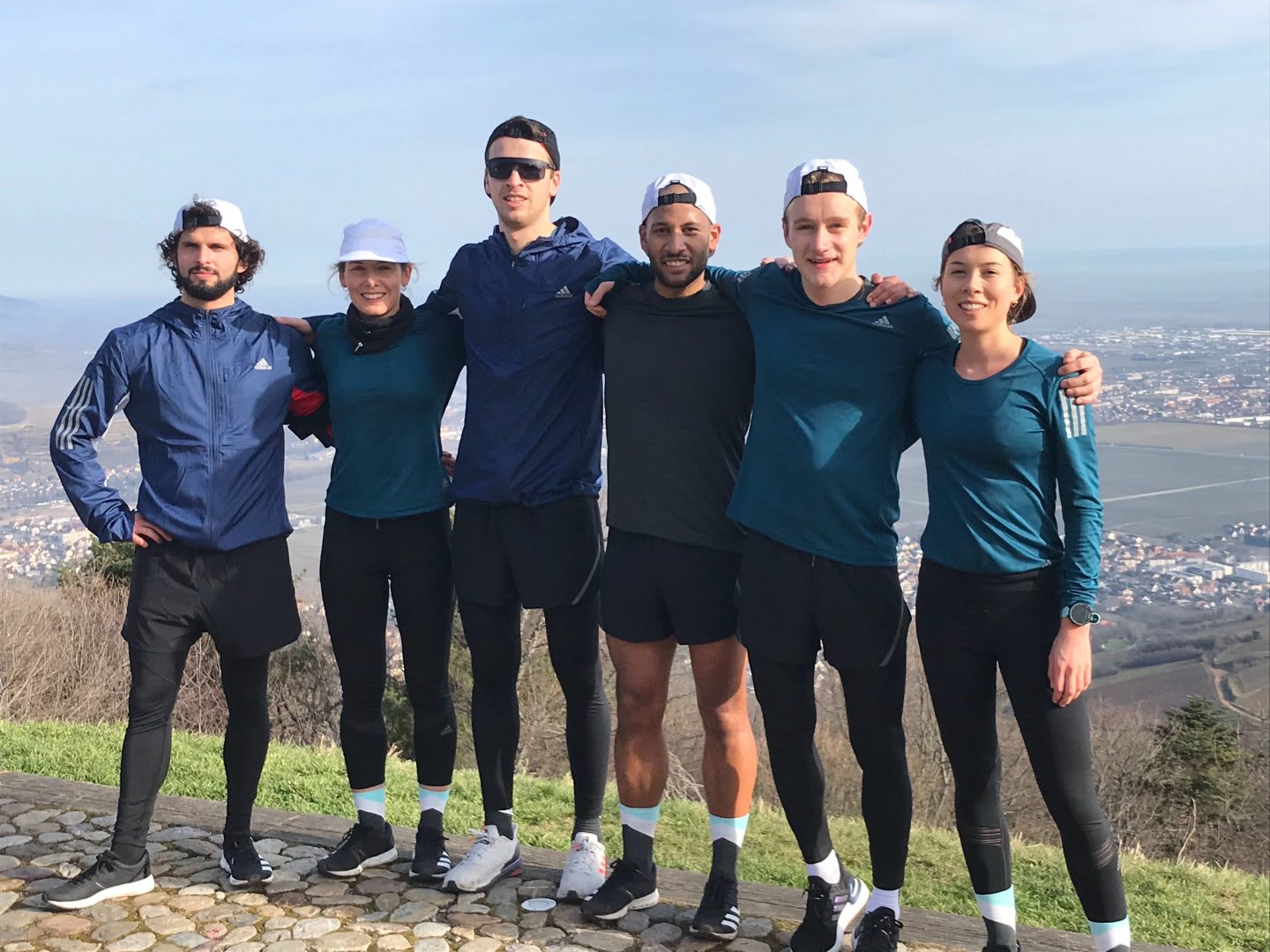 six runners posing for an image on top of a hilll, The Speed Project