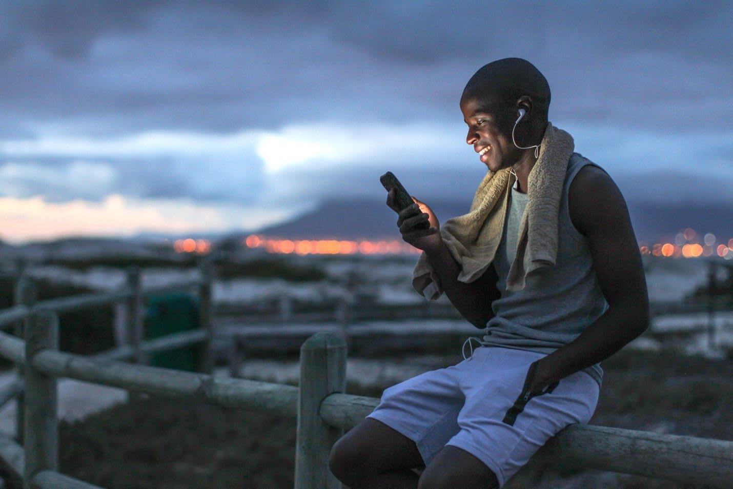 Men looking at smartphone while smiling. accountability partner, GamePlanA