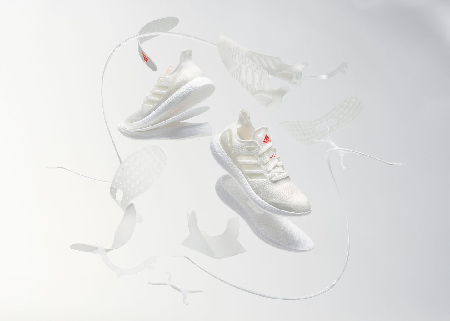 A pair of white sneakers floating around white material, adidas, FUTURECRAFT, LOOP, recycle, remade, sustainability