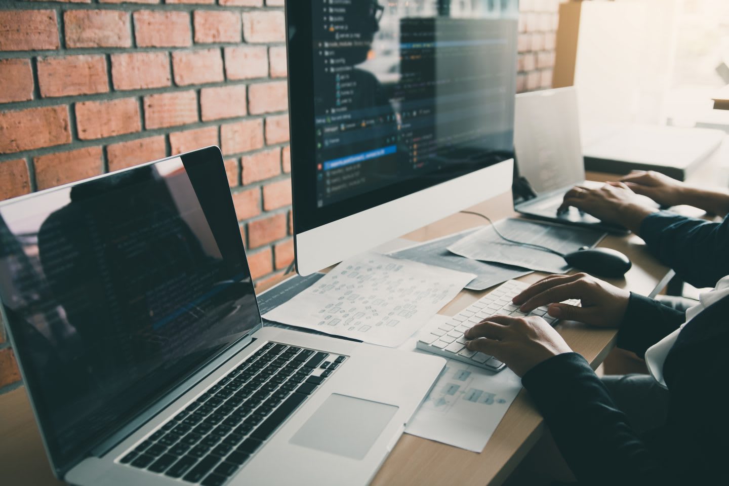 Two partnerships developing programming and coding technologies working on laptop and analyzing together, laptop, desktop, computer, Mac, working, home office, work