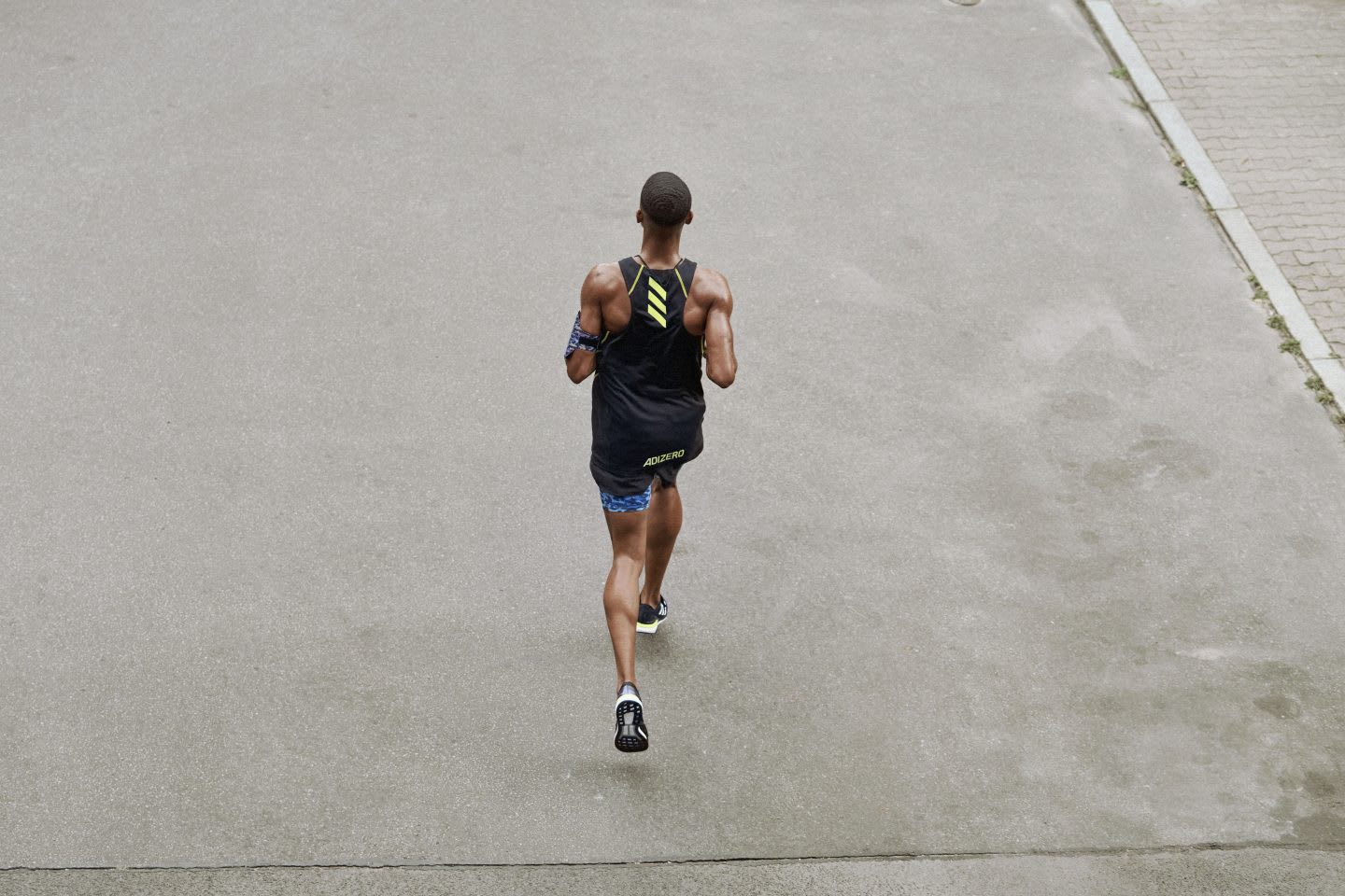 Man running through buildings, concentration, sport, focus, adidas, strong, running