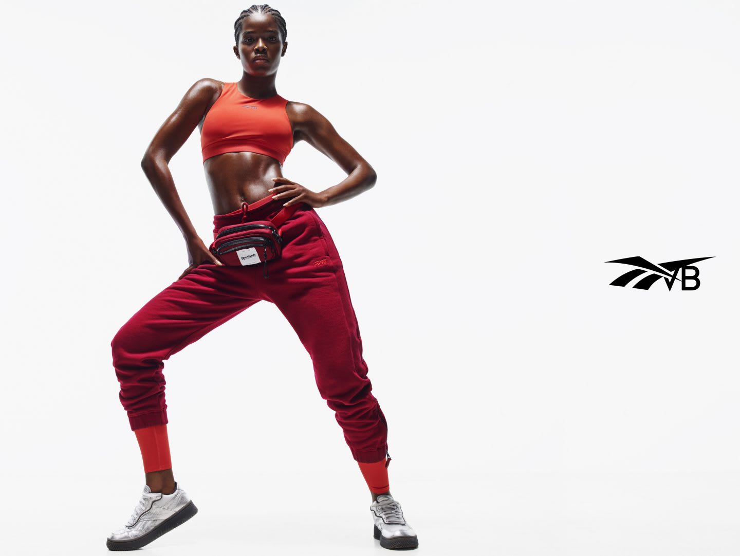 Black model wearing VB x Reebok red outfit from streetwear collection, Victoria Beckham, Reebok, collaboration, fashion