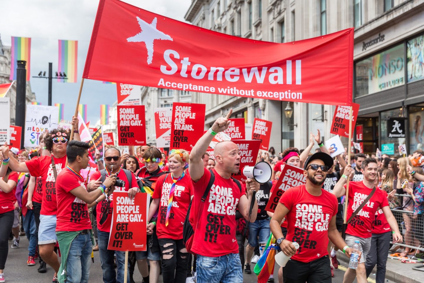 Men and women wearing red t-shirts during a march at London Pride Parade in 2016, Stonewall, LGBTQ, inclusion, diversity