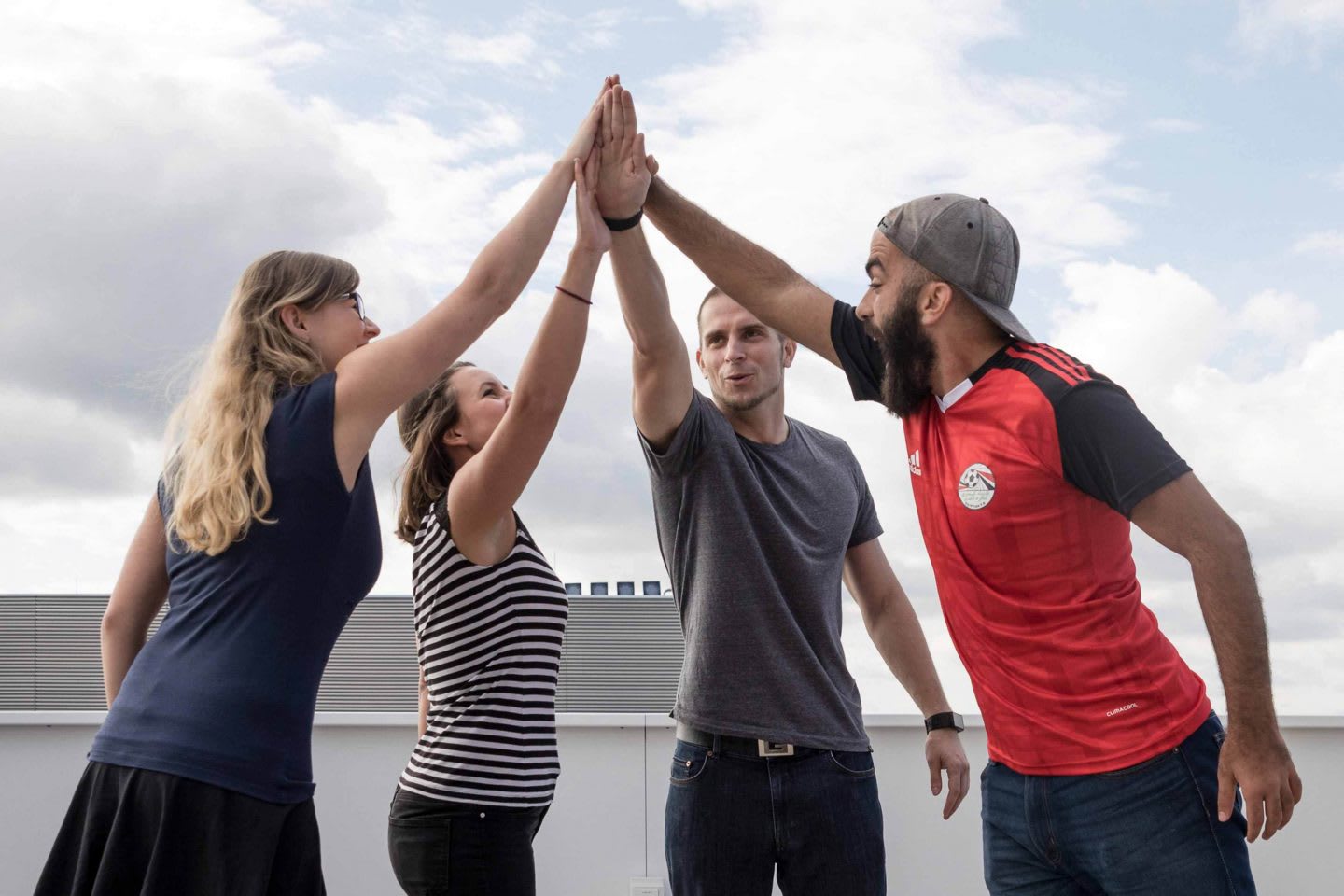 Men and women joining hands in a circle, teamwork, collaboration, team spirit, colleagues, Runtastic, Linz, Austria