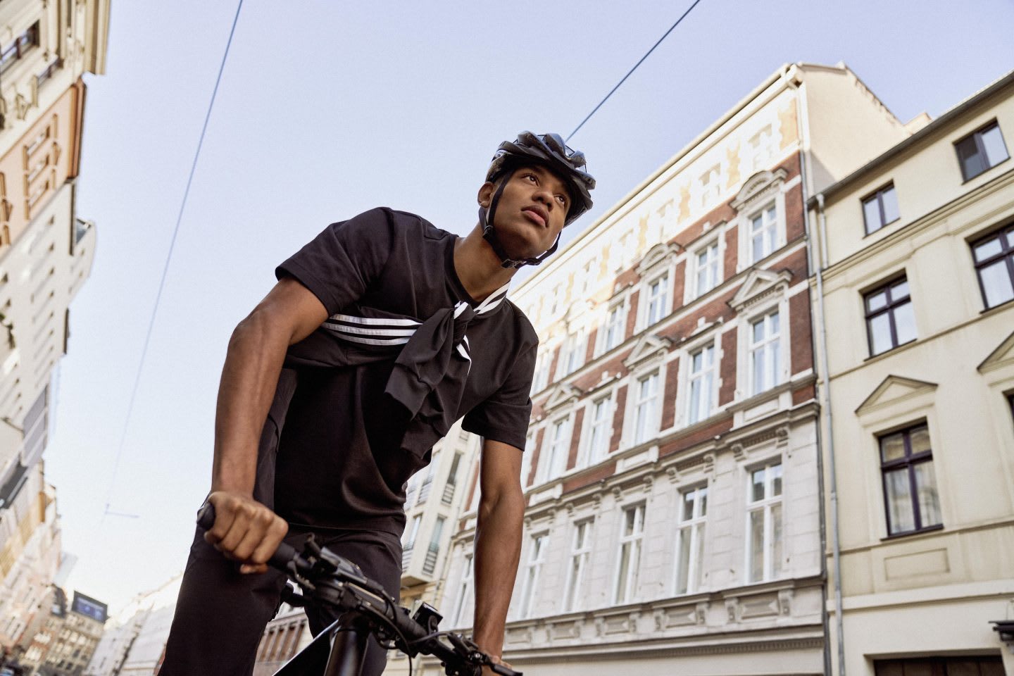 Man wearing bike helmet cycling in a metropolitan city, sports, bike, cycling, cycle, cyclists, adidas