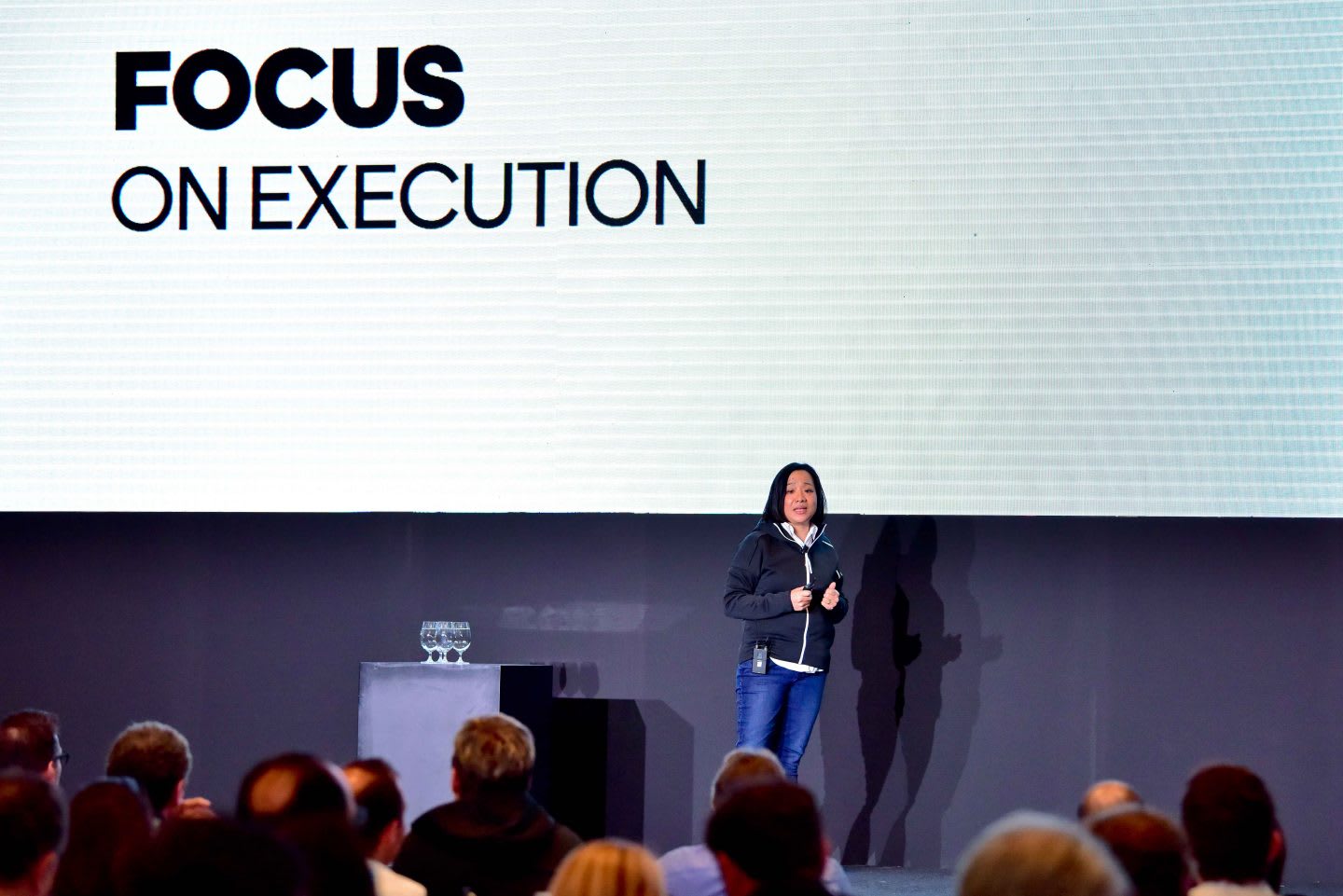 Woman speaking on stage in front of a group of people, public, speaking, Hoa Ly, adidas, woman, leadership, leader, Sourcing, Asia