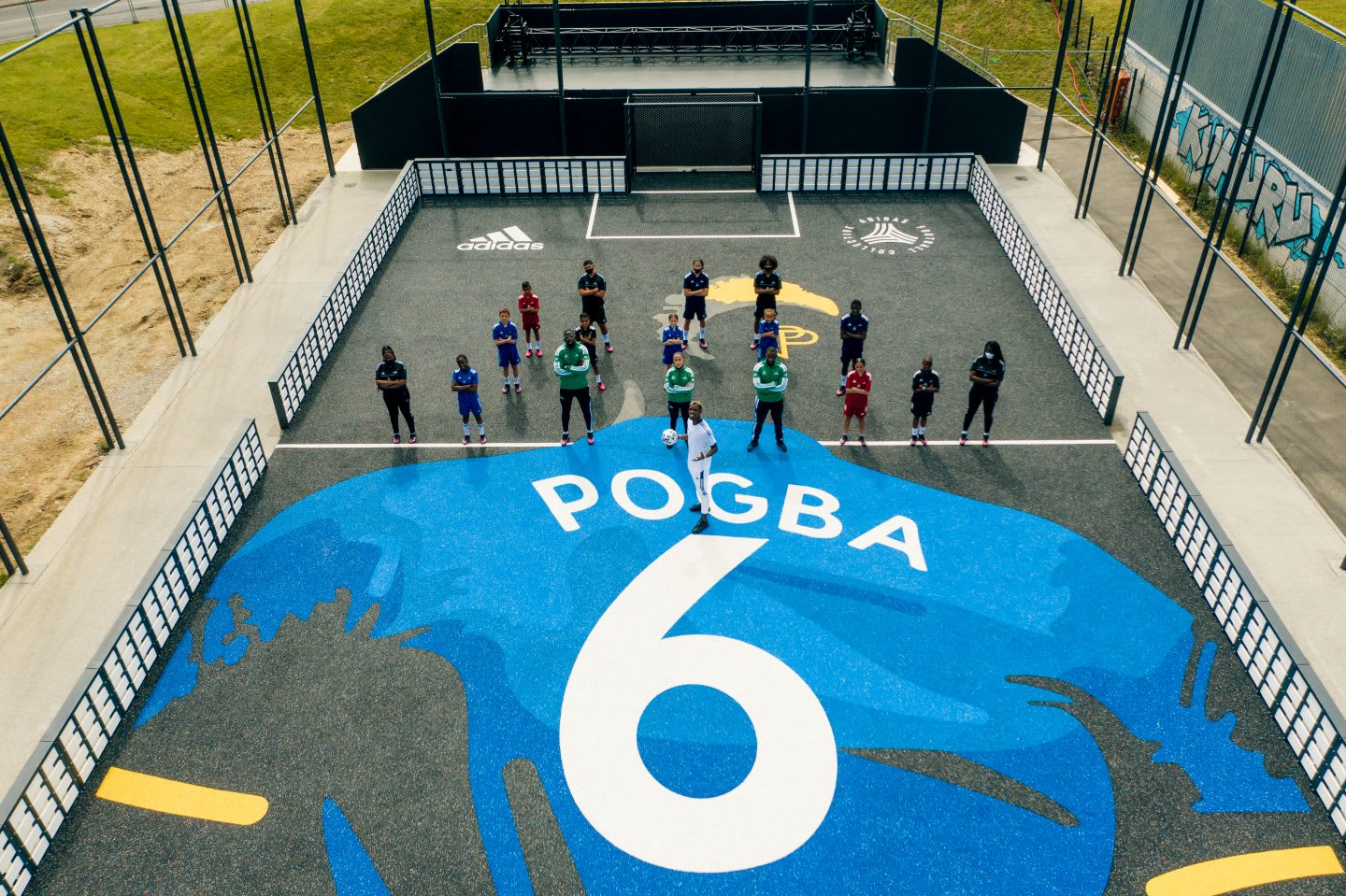 Pogba standing with a group of people on his court. football, community, france, football court, playing football