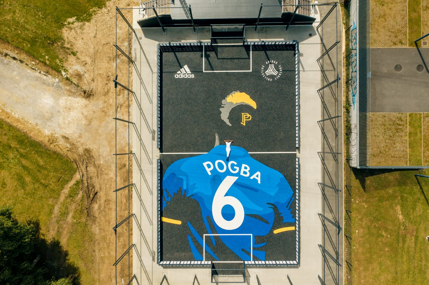 Paul Pogba laying on his own football court. France, star, football, community, possibilities, playing football