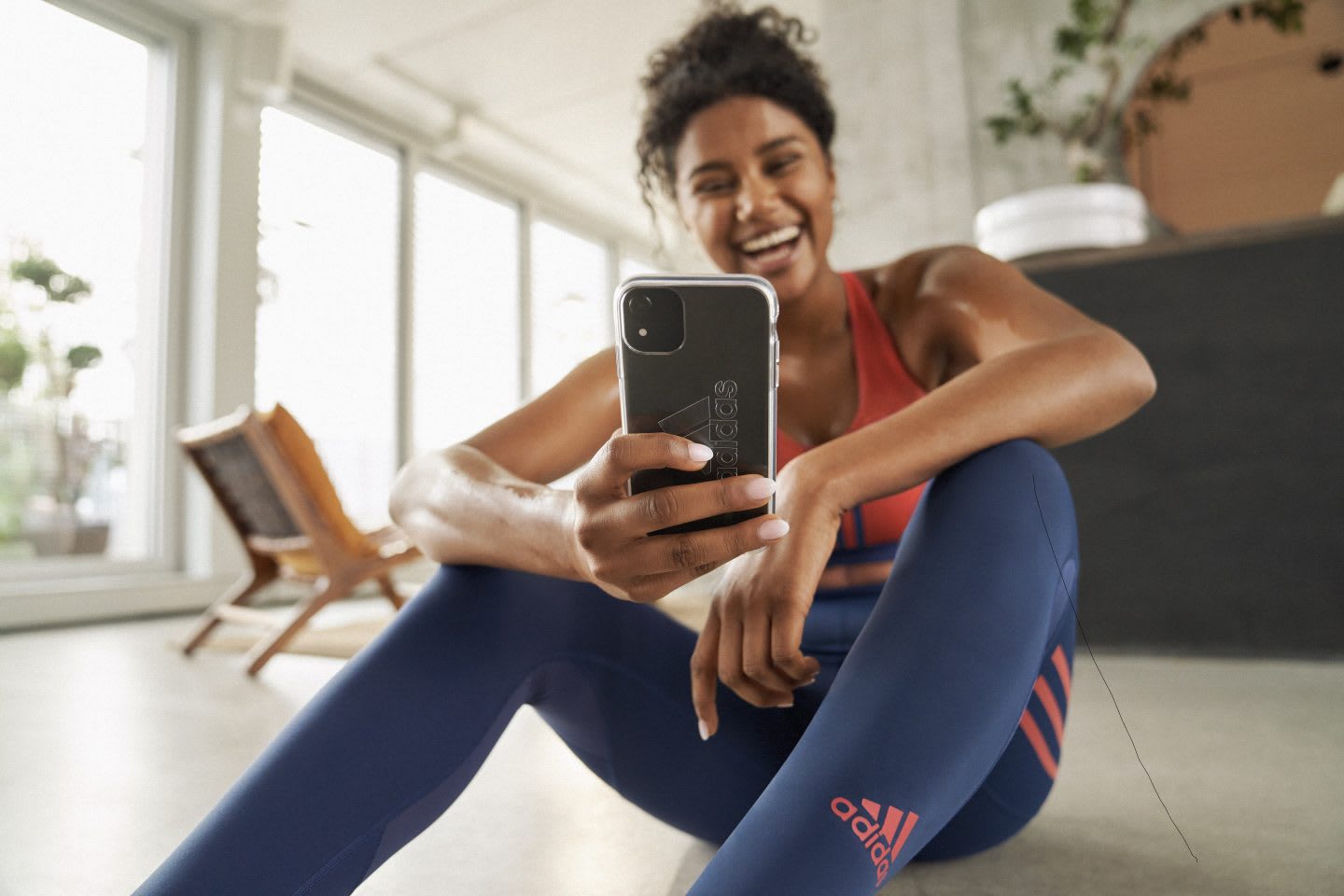 Woman relaxing after workout with the phone. Remote resume, adidas, training, workout, skills