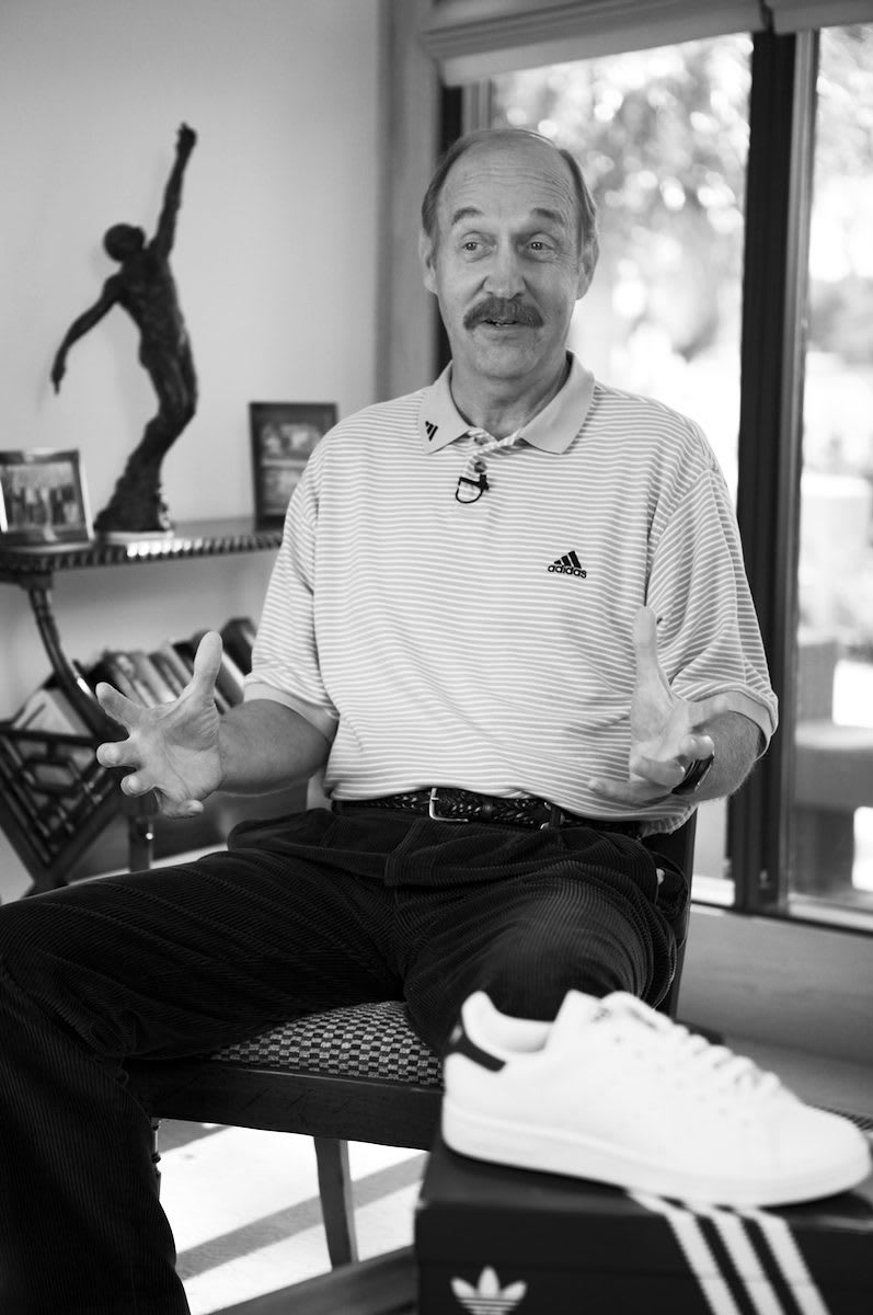 Black and white picture of man wearing adidas polo shirt gesturing while speaking, Stan Smith, tennis, player, athlete, sports, sport