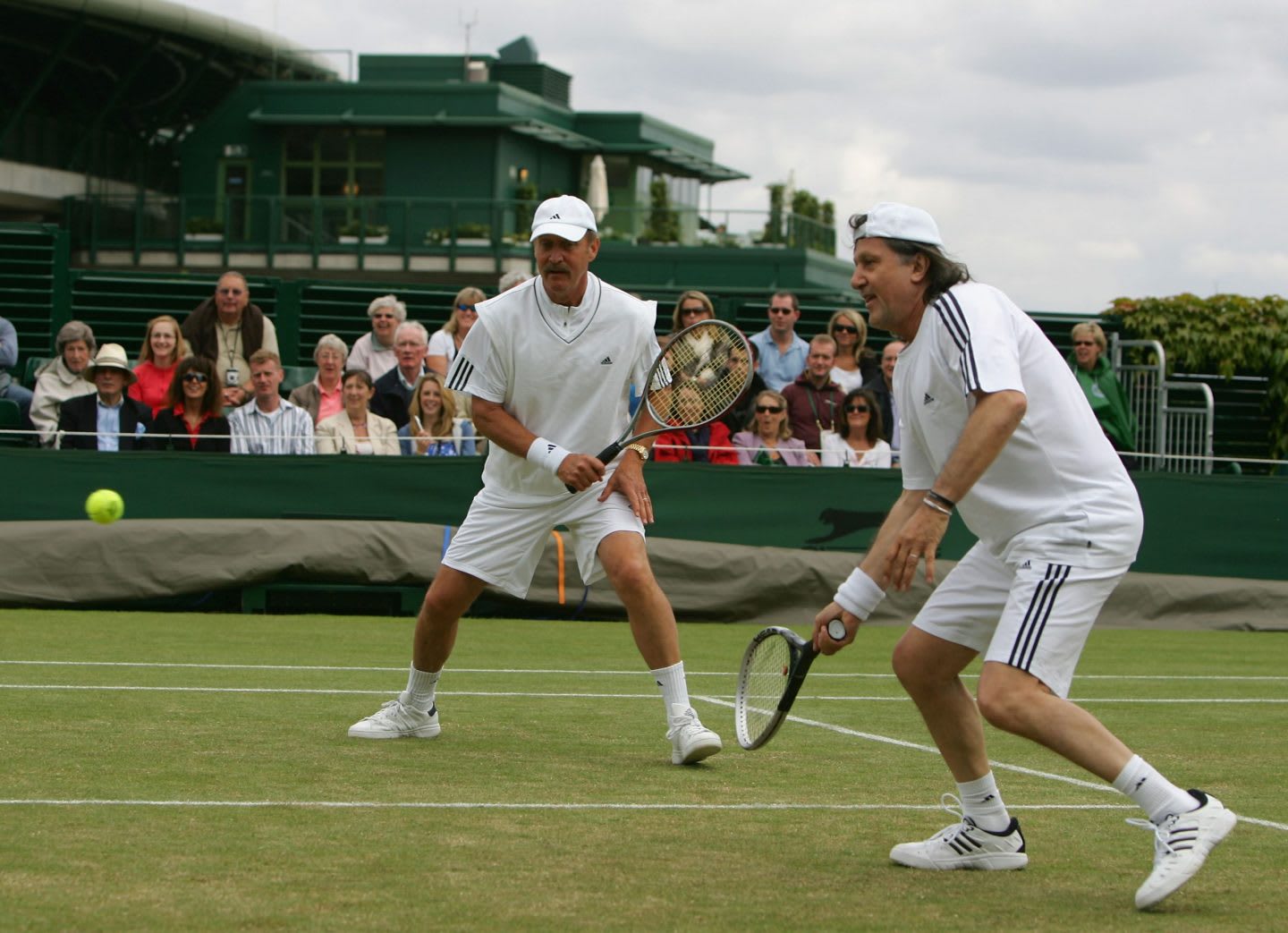 Two men playing a doubles game in tennis on a court, Stan Smith, Ilie Nastase, tennis, athlete, athletes, sports, sport, London,