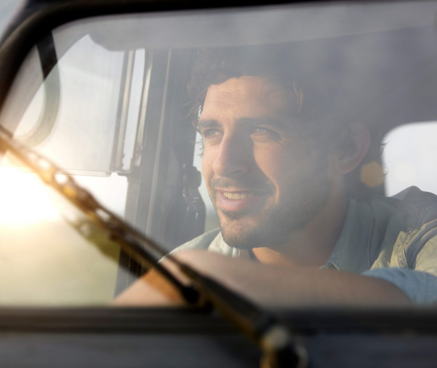 Picture of man smiling while driving through windshield, man, smiling, drive, car